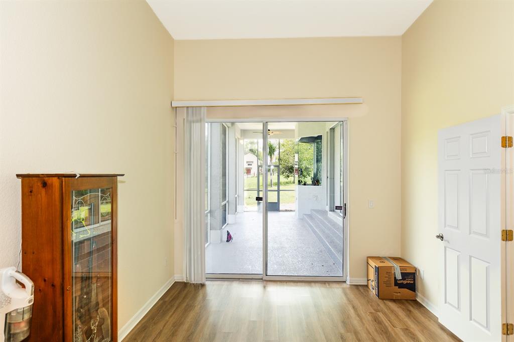 32025 Timberlake Drive Mount Dora, FL 32757 - Photo 14 of 55 a view of a hallway with wooden floor and a living room
