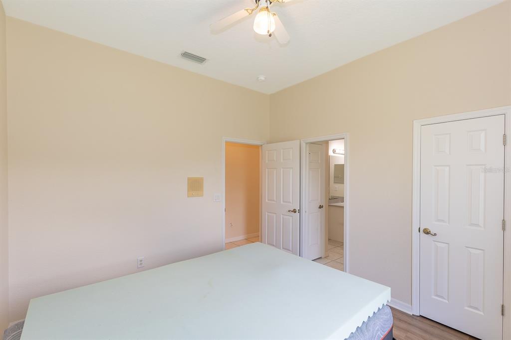 32025 Timberlake Drive Mount Dora, FL 32757 - Photo 24 of 55 a bedroom with a bed and a chandelier fan