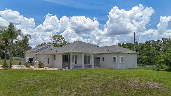 a view of a house with a backyard