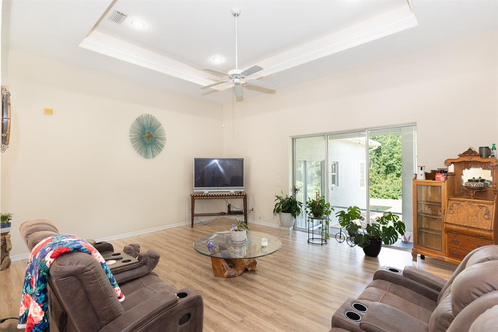 32025 Timberlake Drive Mount Dora, FL 32757 - Photo 33 of 55 a living room with furniture and a flat screen tv