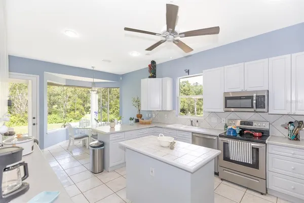 a kitchen with a sink window and cabinets