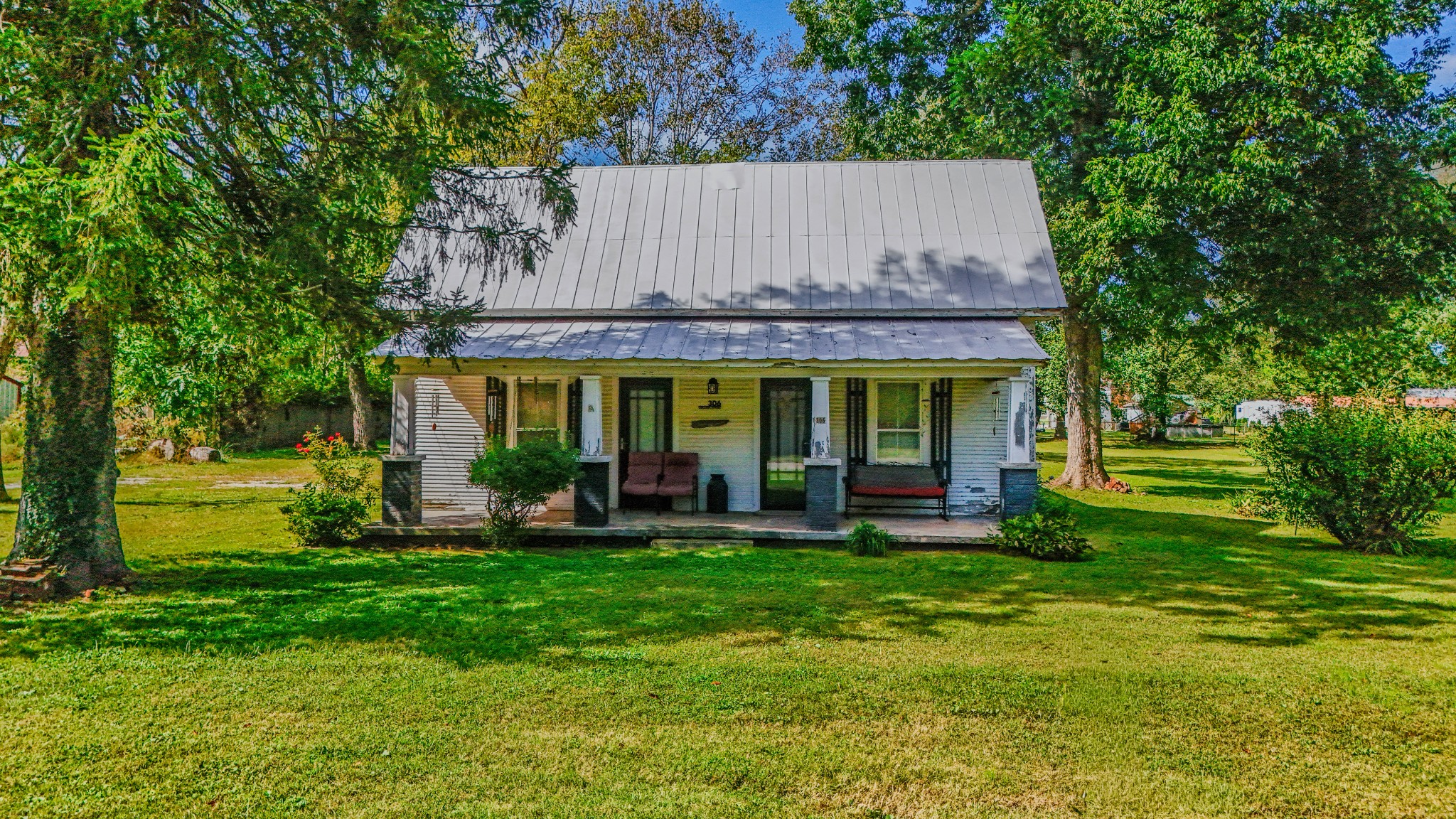 a view of a house with a yard and sitting area