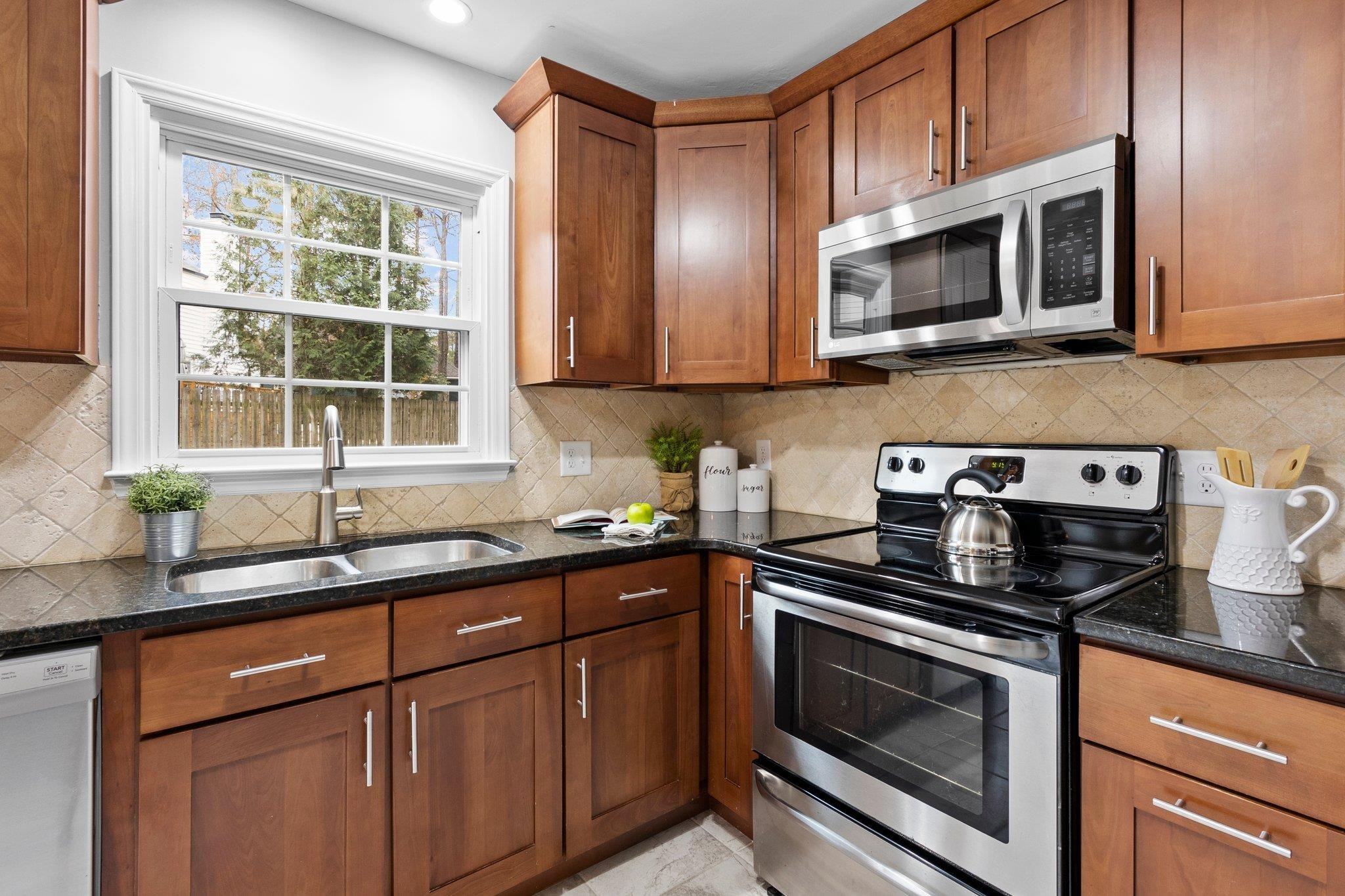 5616 Torness Court Raleigh, NC 27604 - Photo 8 of 37 Updated Kitchen with SS appliances and granite countertops. Kitchen