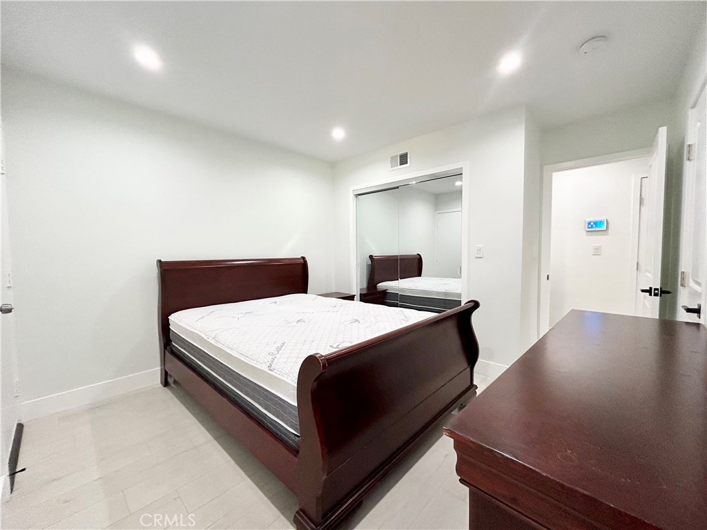 16754 Armstead Street Granada Hills, CA 91344 - Photo 12 of 28 a bedroom with a bed and window