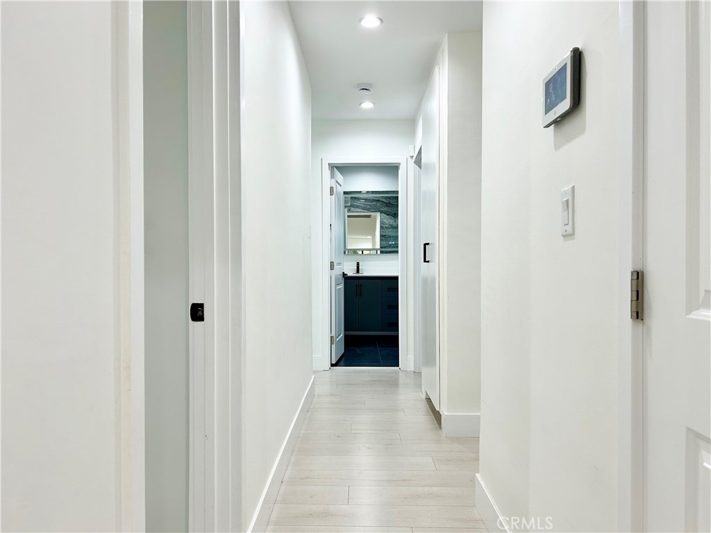 16754 Armstead Street Granada Hills, CA 91344 - Photo 13 of 28 a view of a hallway with white walls