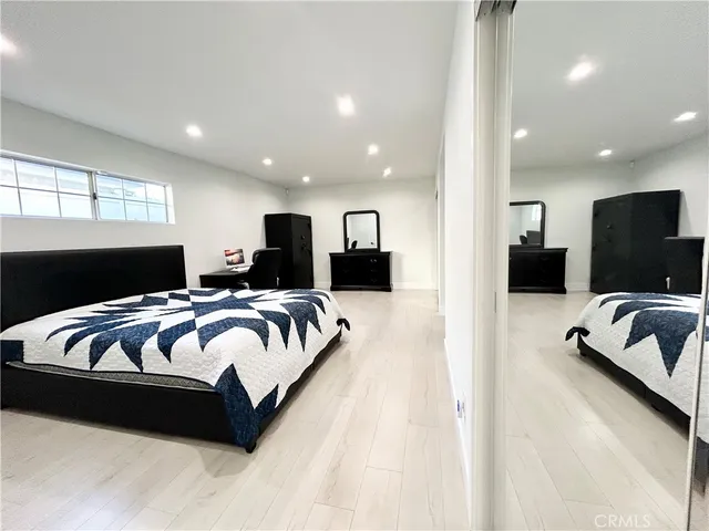 a hotel room with a bed a couch and a view of kitchen
