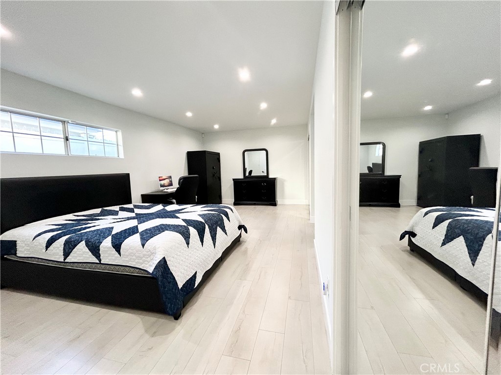 16754 Armstead Street Granada Hills, CA 91344 - Photo 14 of 28 a spacious bedroom with a bed and a couch