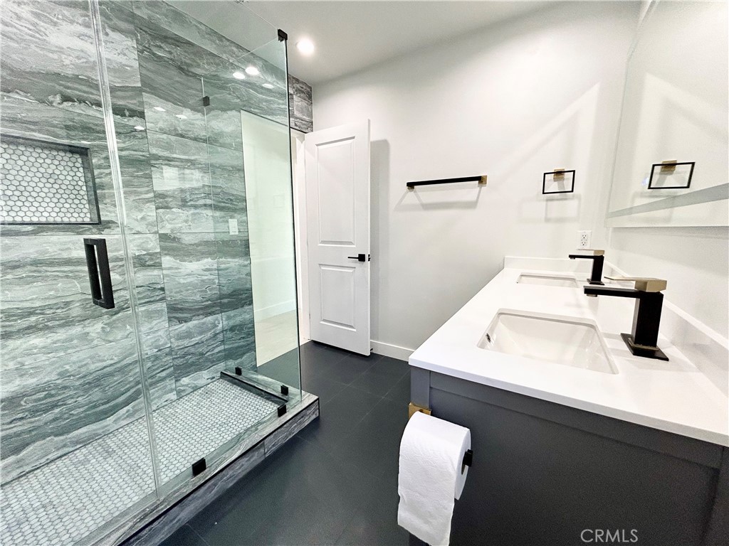 16754 Armstead Street Granada Hills, CA 91344 - Photo 18 of 28 a bathroom with a sink and mirror