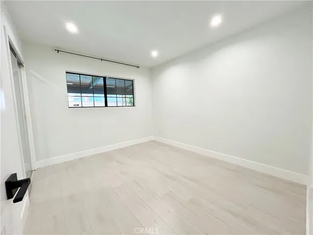 an empty room with windows and closet