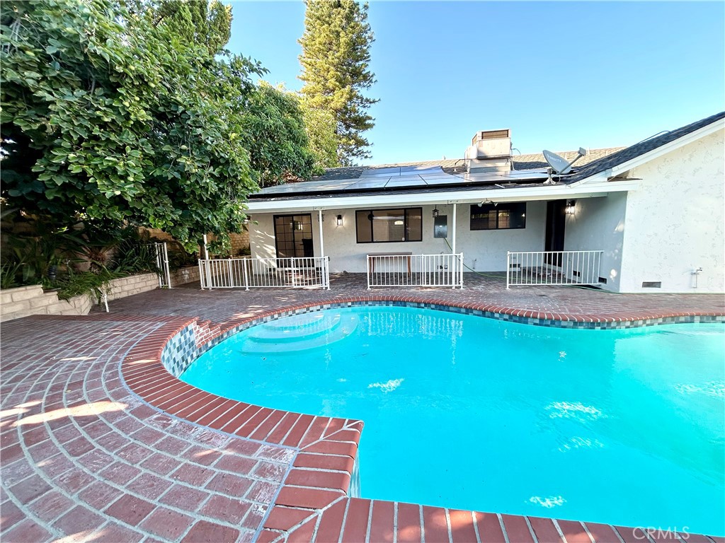 16754 Armstead Street Granada Hills, CA 91344 - Photo 22 of 28 a view of a house with pool and chairs