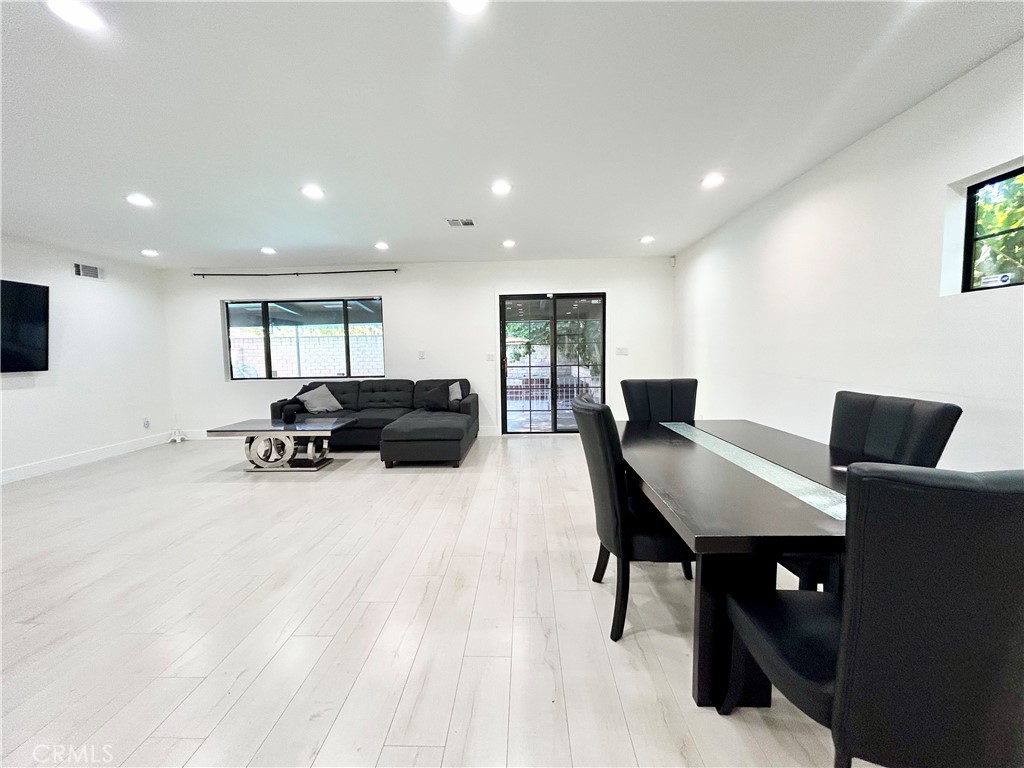 16754 Armstead Street Granada Hills, CA 91344 - Photo 5 of 28 a living room with furniture a desk and a flat screen tv