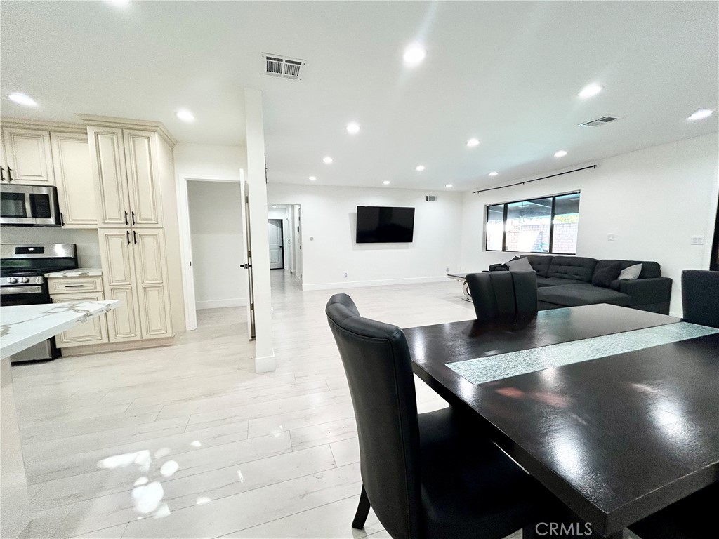 16754 Armstead Street Granada Hills, CA 91344 - Photo 6 of 28 a large kitchen with a table and chairs