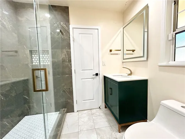 a bathroom with a shower and a sink