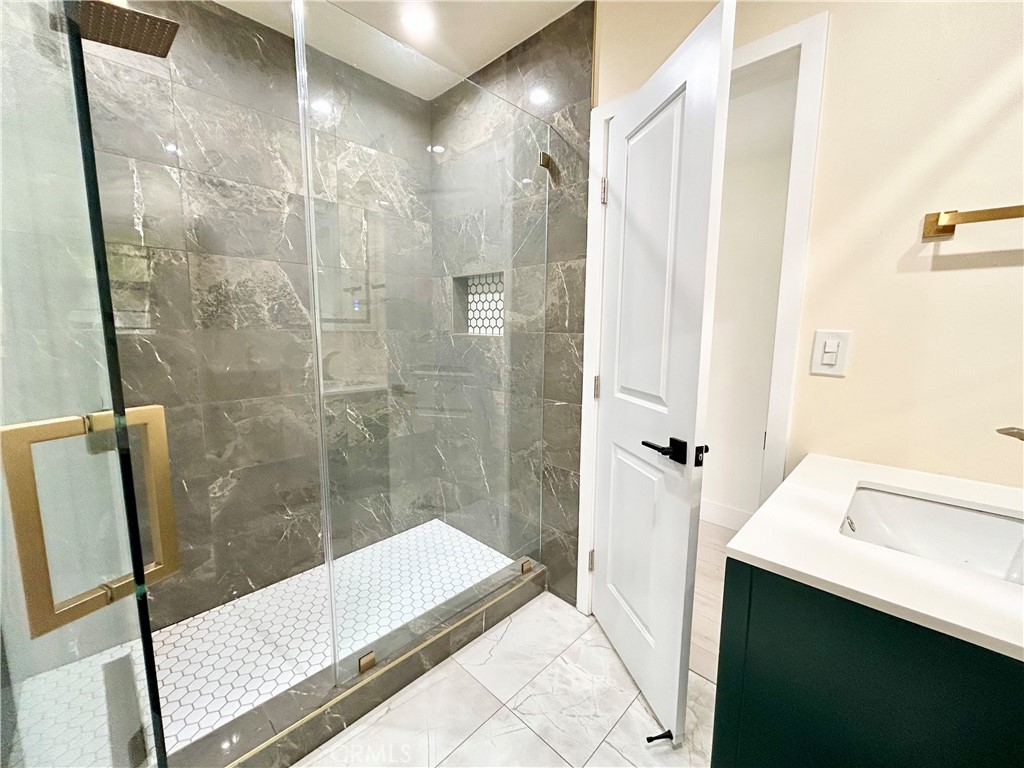 16754 Armstead Street Granada Hills, CA 91344 - Photo 10 of 28 a bathroom with a shower and a sink