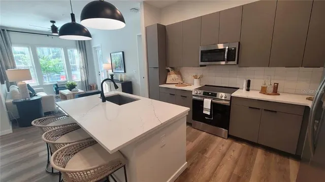 a kitchen with a table chairs stove and microwave
