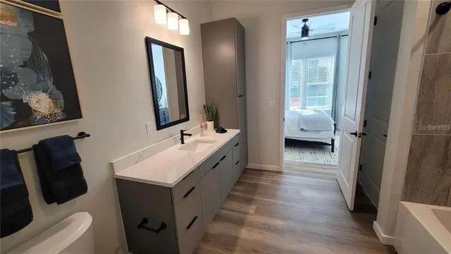 a bathroom with a sink a toilet and mirror
