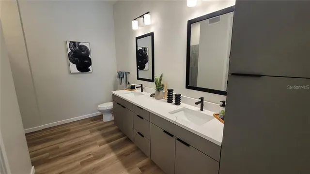 a bathroom with 2 sink and a mirror