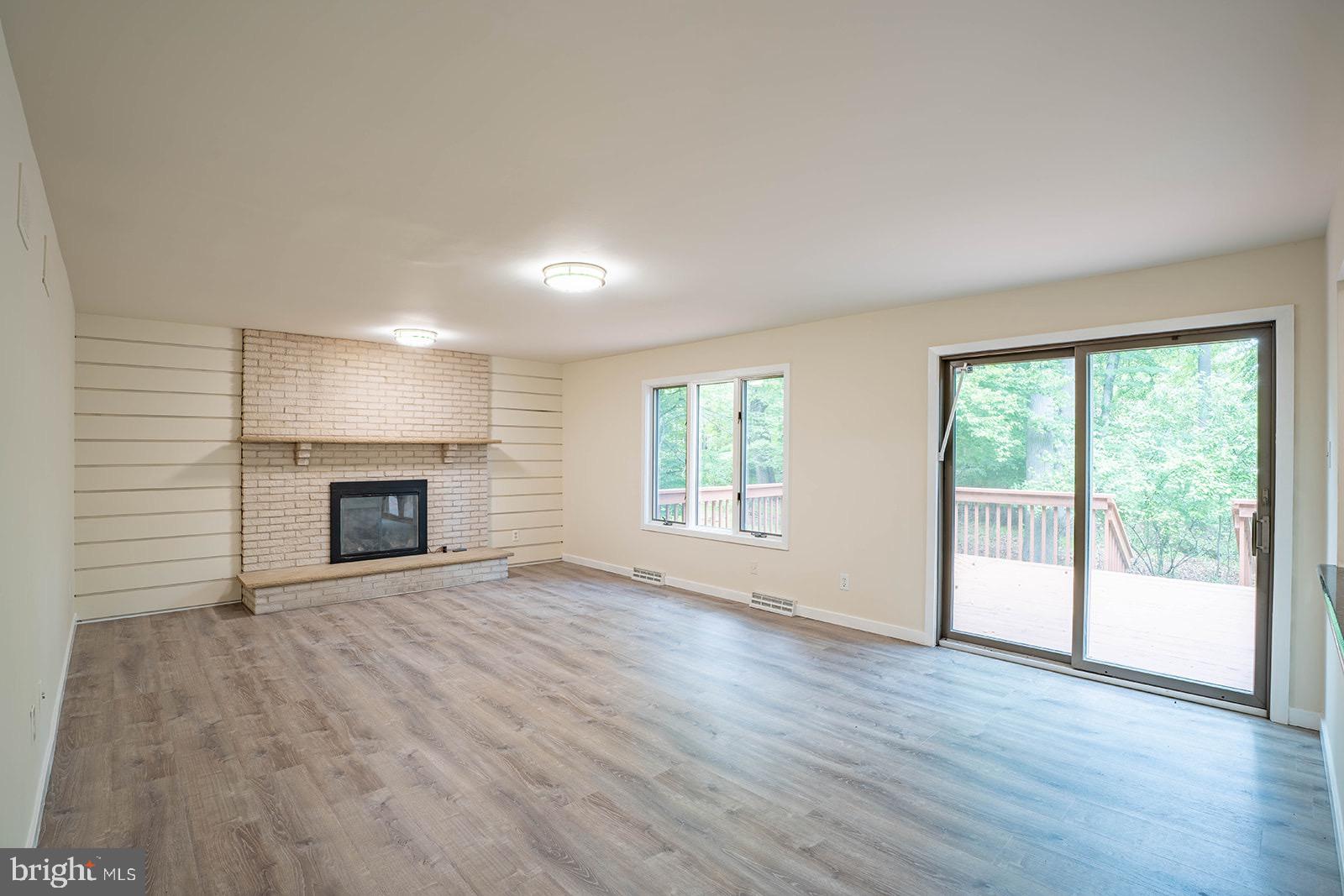 491 Kings Road Yardley, PA 19067 - Photo 20 of 52 an empty room with wooden floor fireplace and windows