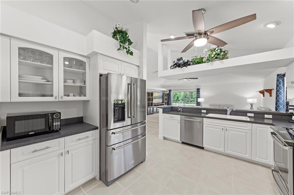 13541 Stringfellow Road Bokeelia, FL 33922 - Photo 8 of 49 a kitchen with a refrigerator and a sink