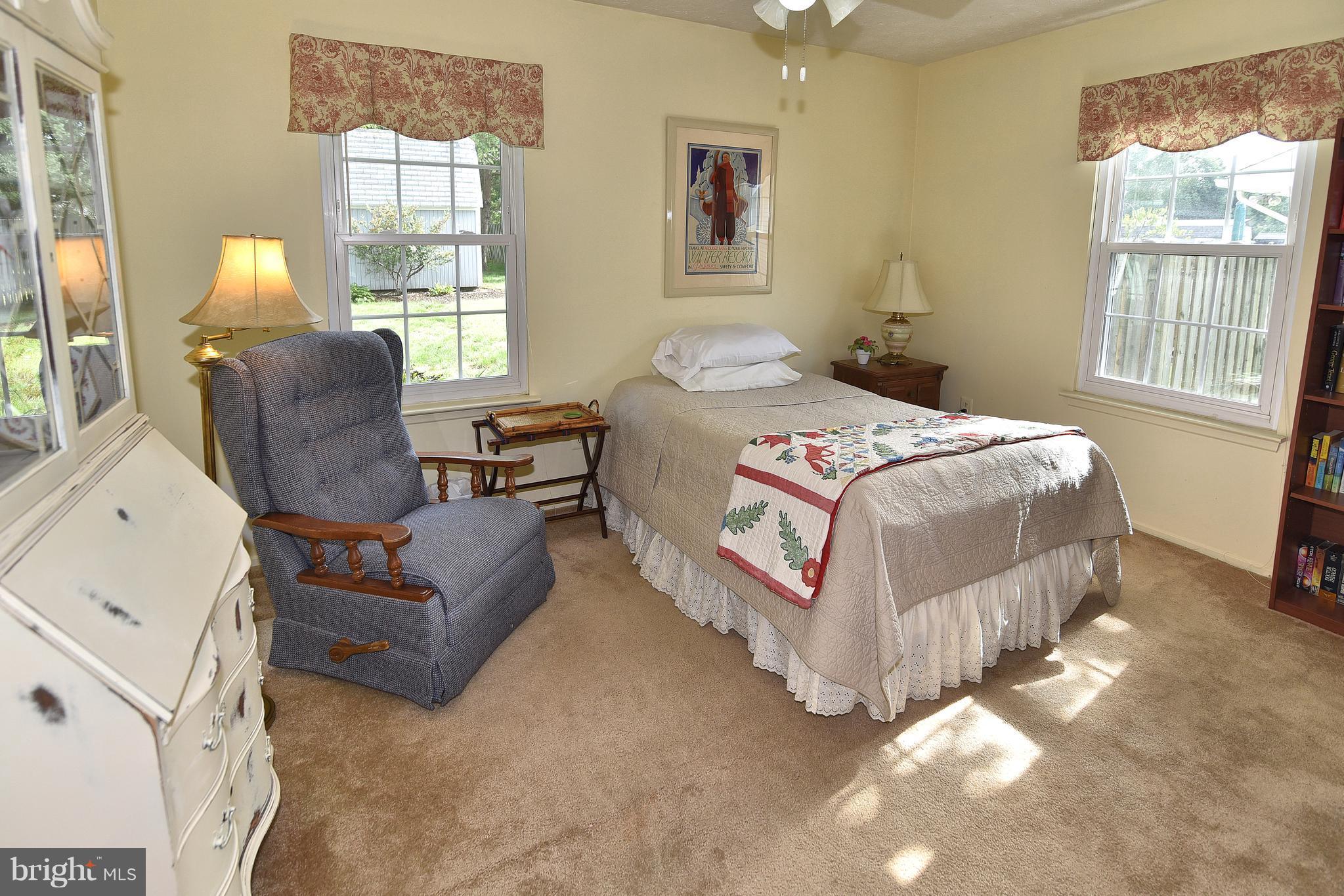 8219 Grainfield Road Severn, MD 21144 - Photo 14 of 30 a bedroom with a bed couch and window