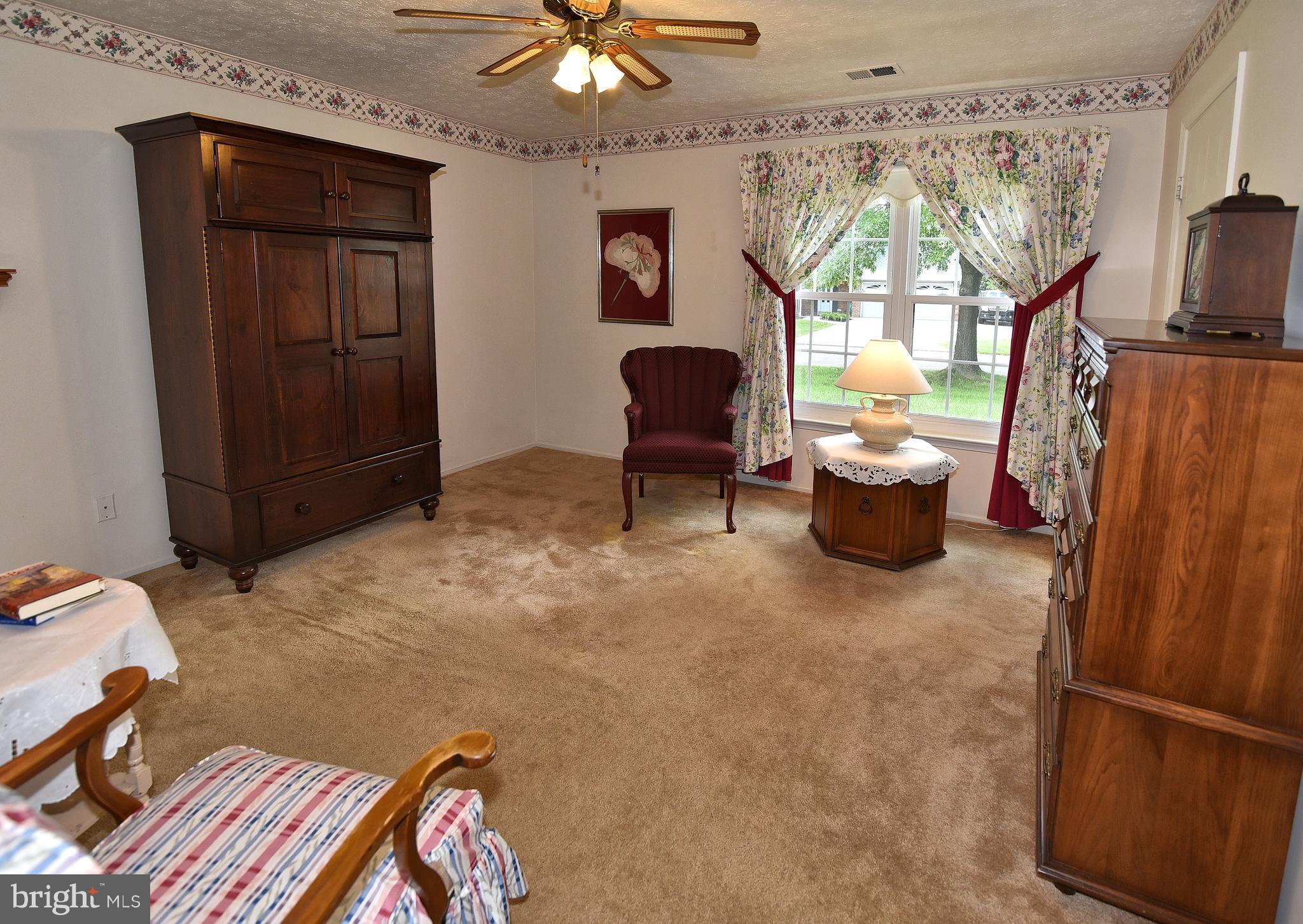 8219 Grainfield Road Severn, MD 21144 - Photo 18 of 30 a living room with furniture a flat screen tv and a large window