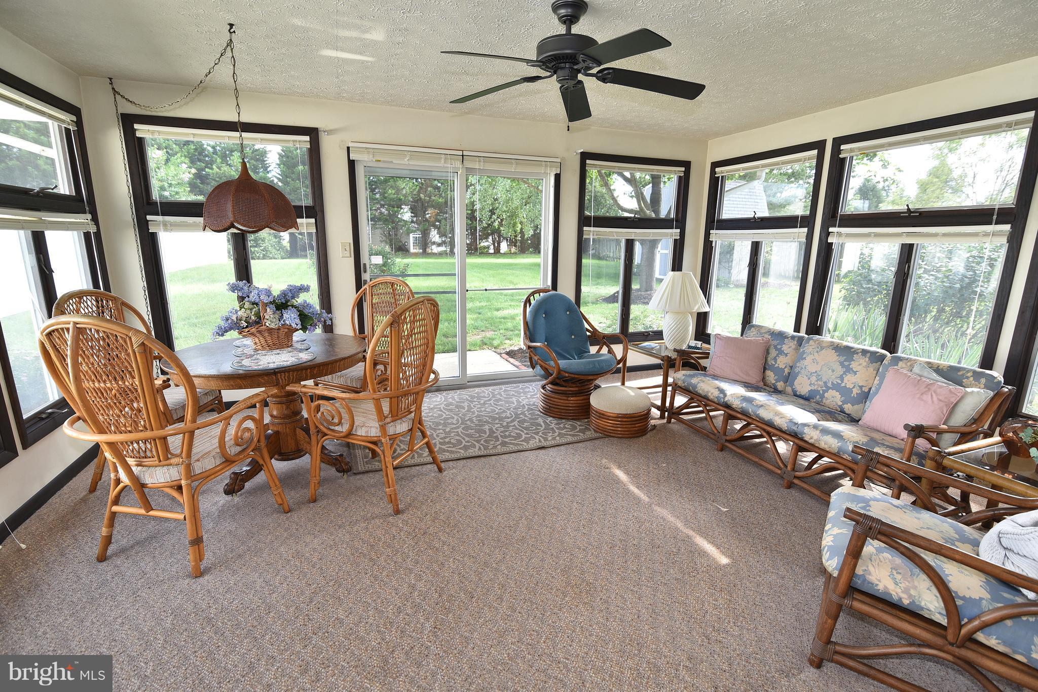 8219 Grainfield Road Severn, MD 21144 - Photo 21 of 30 a living room with furniture and a floor to ceiling window