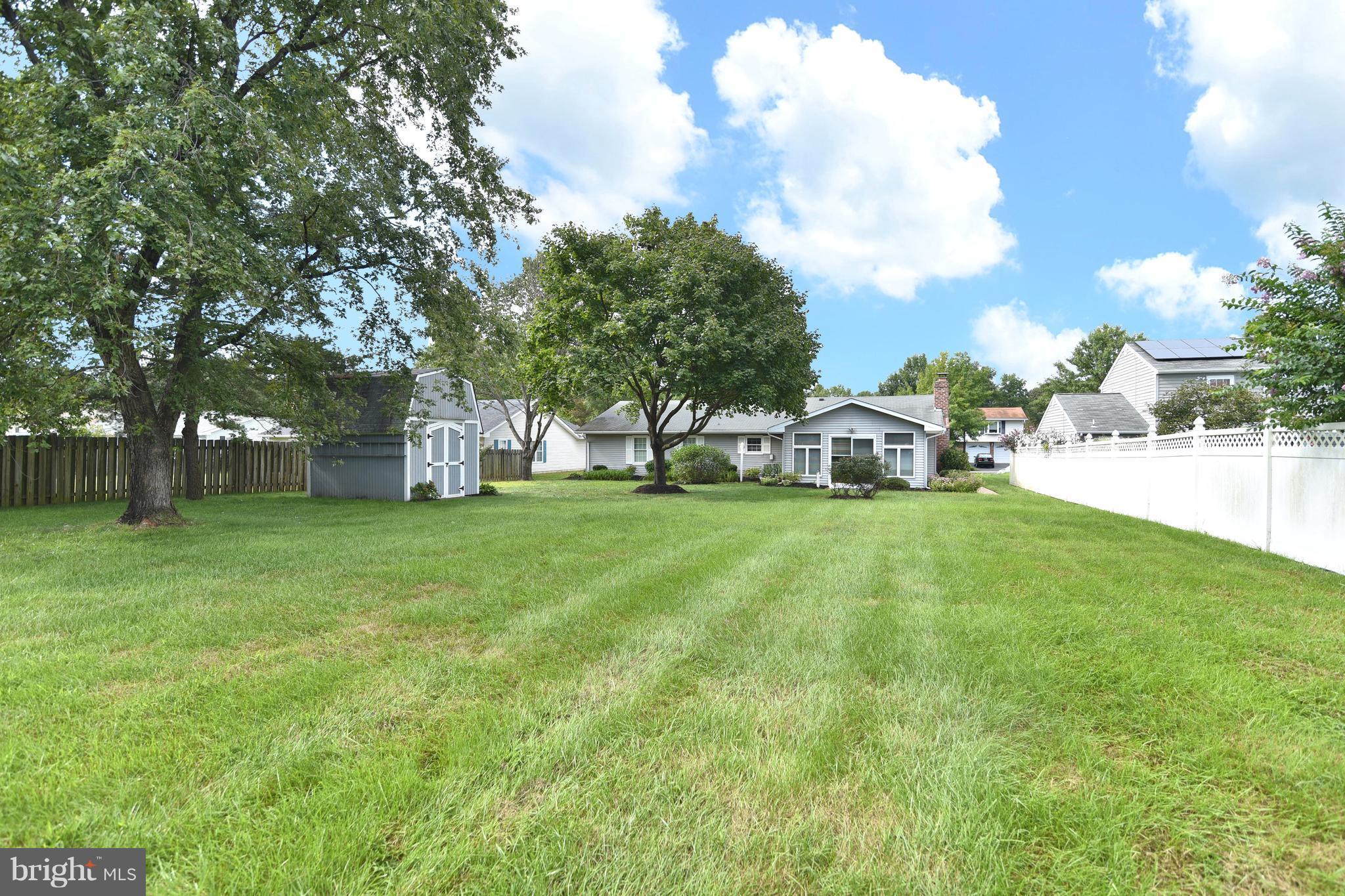 8219 Grainfield Road Severn, MD 21144 - Photo 25 of 30 a view of a house with a big yard and large trees
