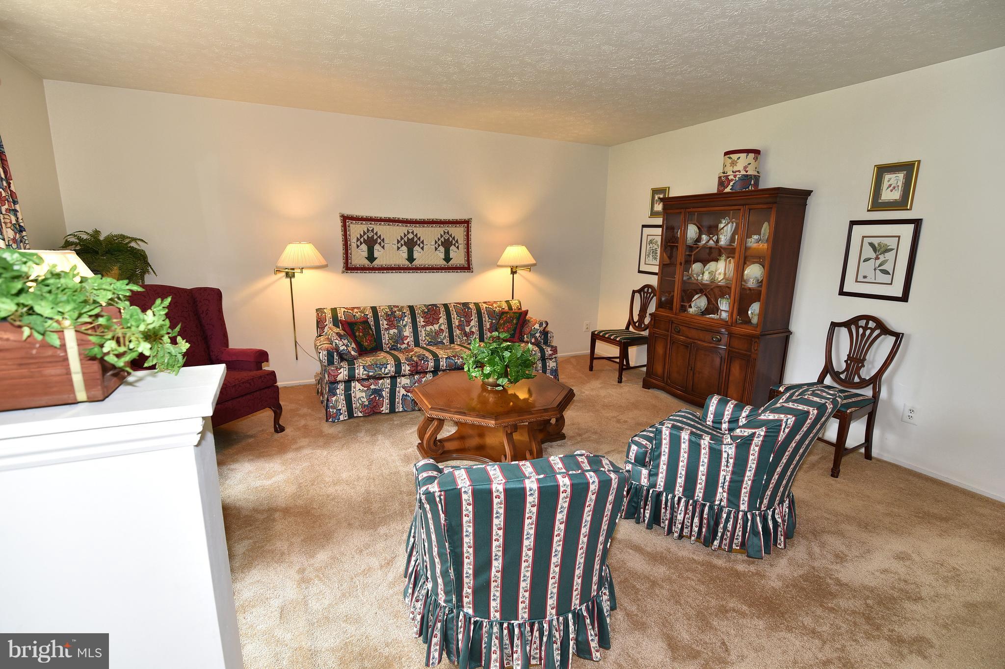 8219 Grainfield Road Severn, MD 21144 - Photo 5 of 30 a living room with furniture and a wooden floor