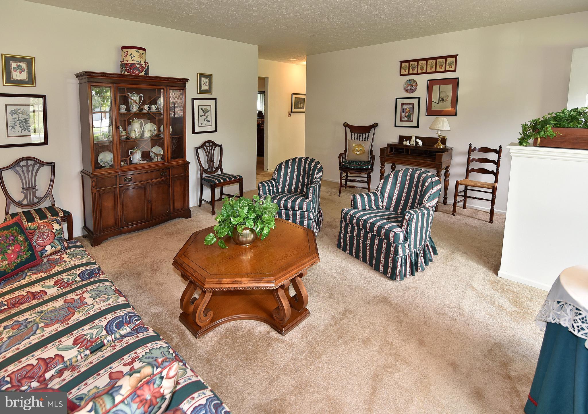 8219 Grainfield Road Severn, MD 21144 - Photo 6 of 30 a room with furniture a rug and a flat screen tv