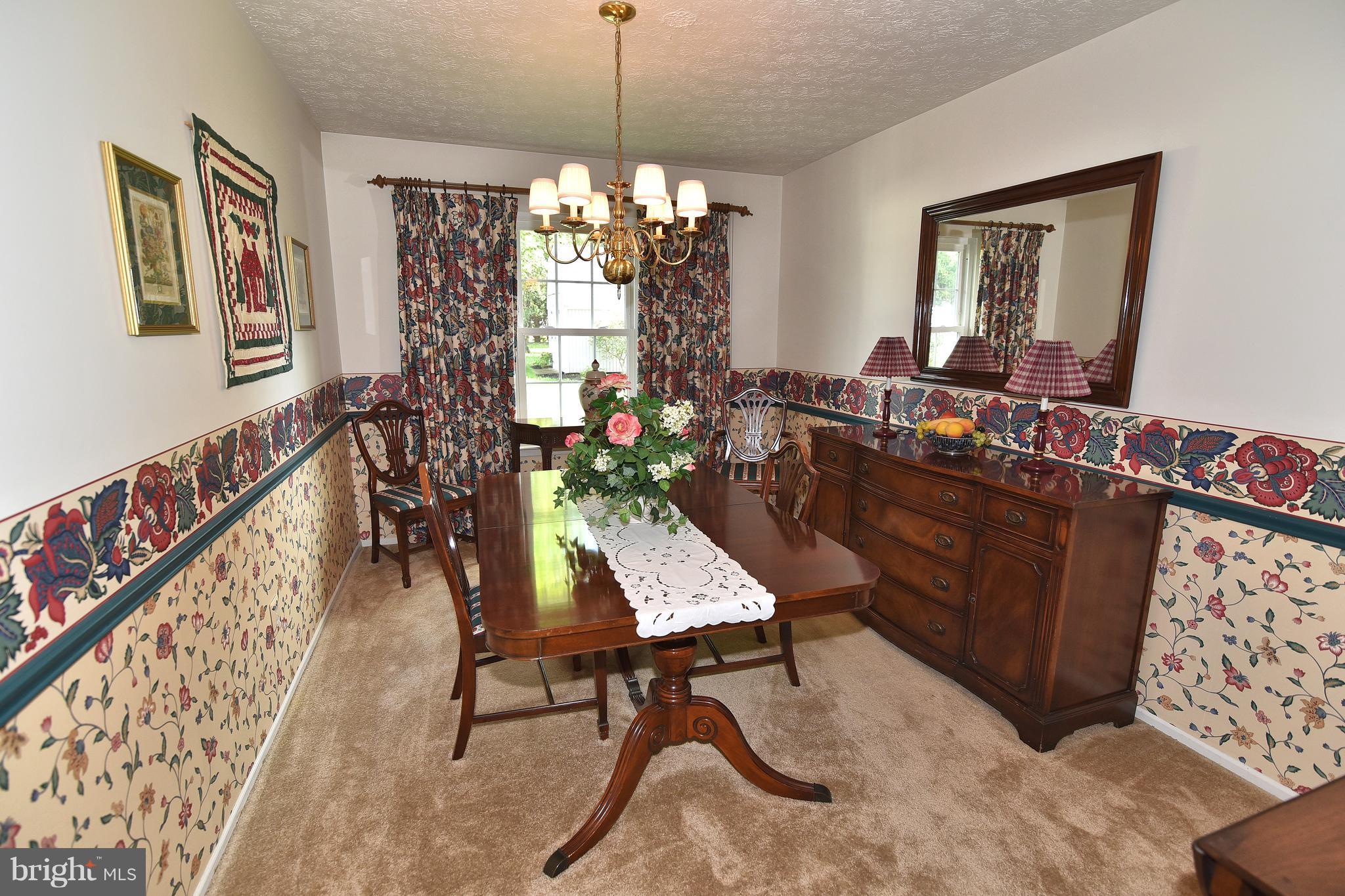 8219 Grainfield Road Severn, MD 21144 - Photo 7 of 30 a room with furniture and a chandelier