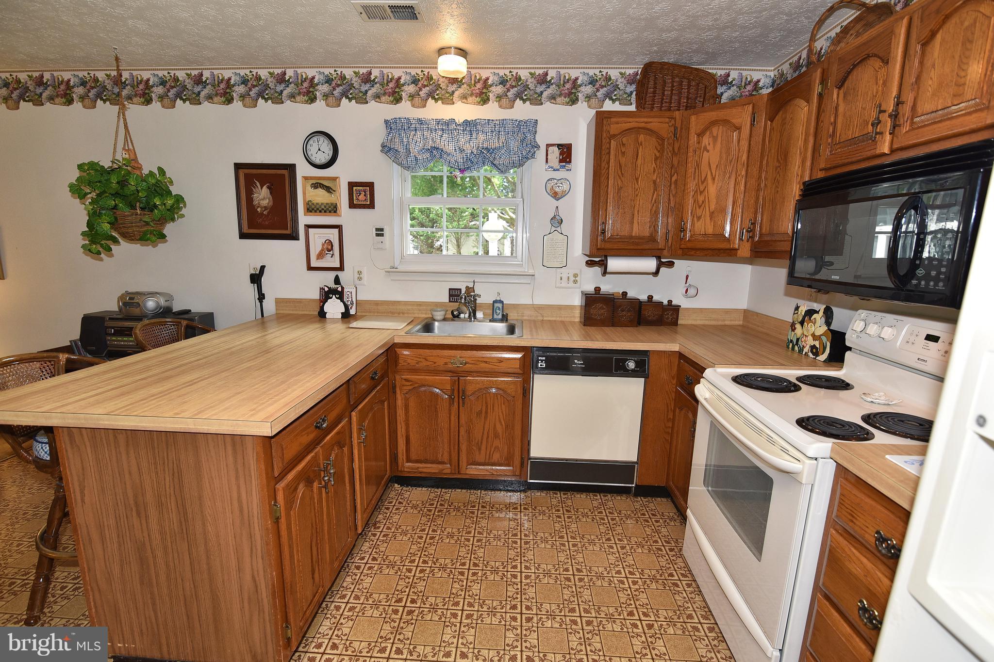8219 Grainfield Road Severn, MD 21144 - Photo 9 of 30 a kitchen with a sink stove and microwave