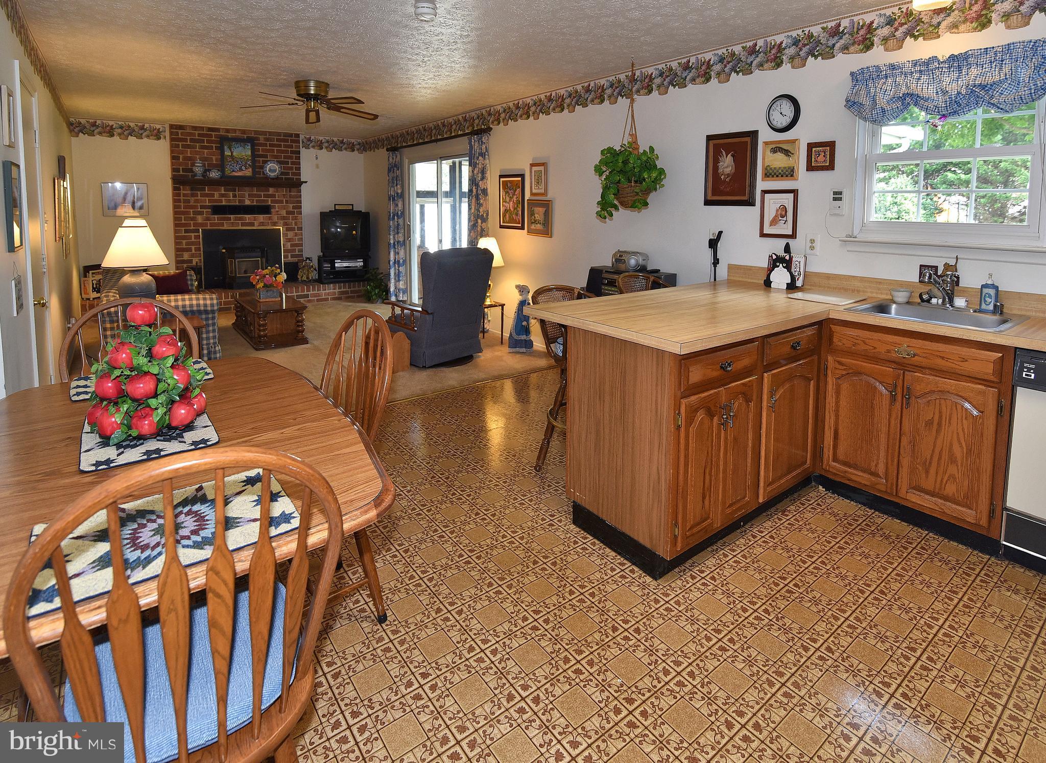 8219 Grainfield Road Severn, MD 21144 - Photo 10 of 30 a kitchen with stainless steel appliances granite countertop a sink stove and wooden cabinets