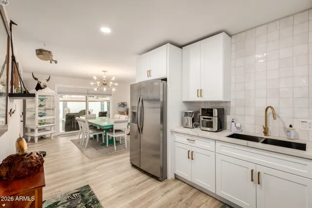 a kitchen with refrigerator and cabinets