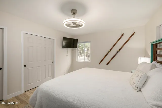 a bedroom with a bed and a flat screen tv