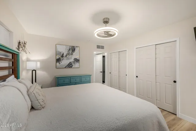 a bedroom with a bed and a chandelier