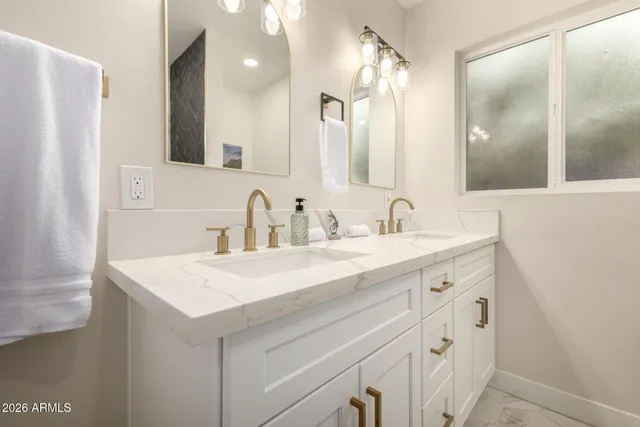 a bathroom with a sink vanity and a mirror