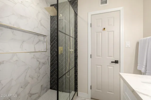a bathroom with a shower and a sink