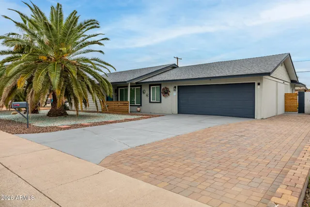 a front view of a building with palm trees