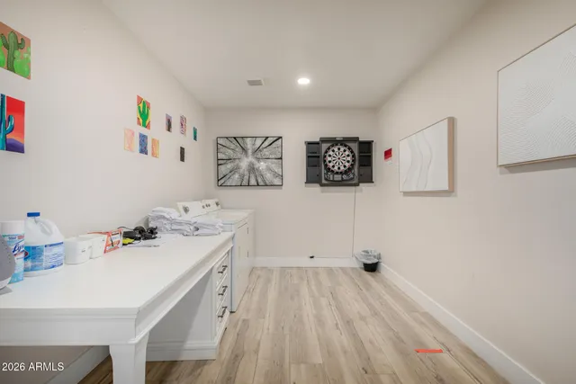 a storage room with a wooden floor and cabinets