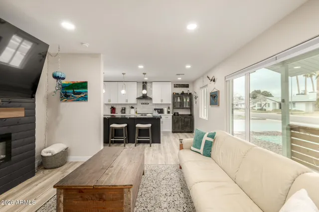 a living room with kitchen island furniture and a flat screen tv