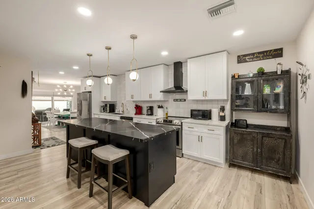 a kitchen with a sink stainless steel appliances and cabinets
