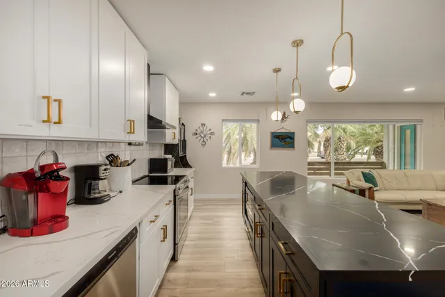 a kitchen with stainless steel appliances granite countertop a sink counter space and cabinets