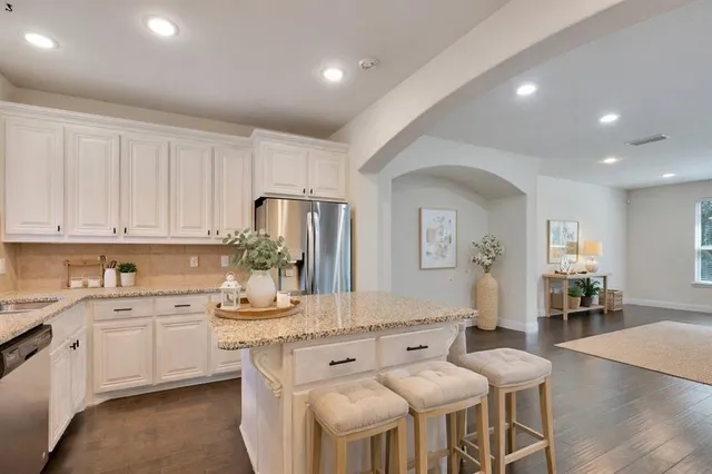 a kitchen with stainless steel appliances granite countertop a sink and cabinets