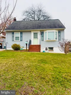 a front view of house with yard and outdoor seating