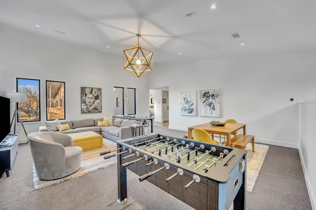 a living room with fireplace furniture and a chandelier