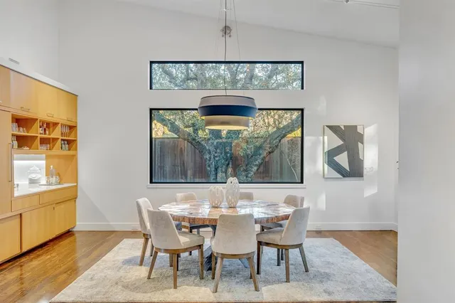 a view of a dining room with furniture and wooden floor