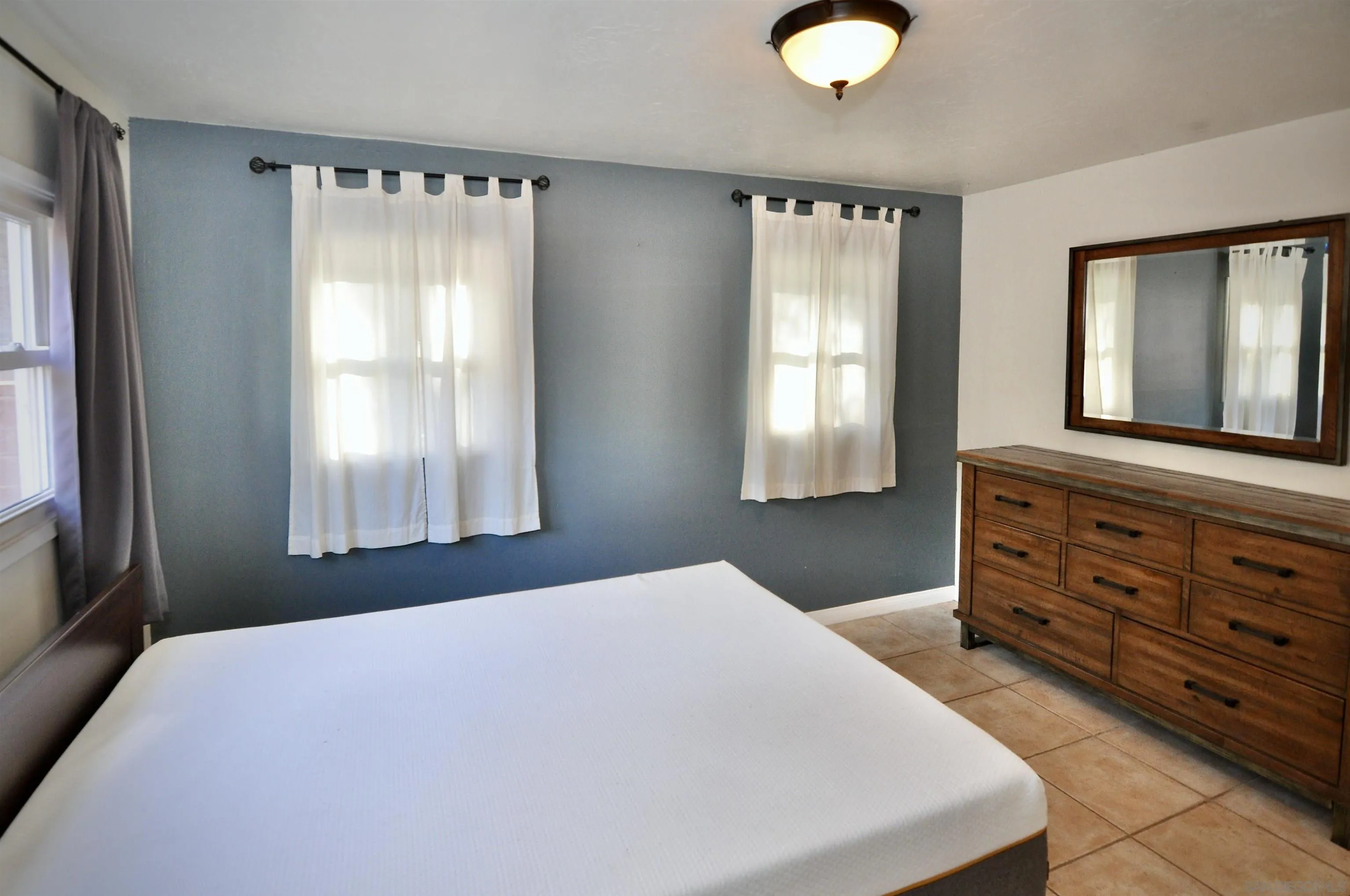 12549 Taunt Place Poway, CA 92064 - Photo 19 of 38 a bedroom with a bed and a dresser