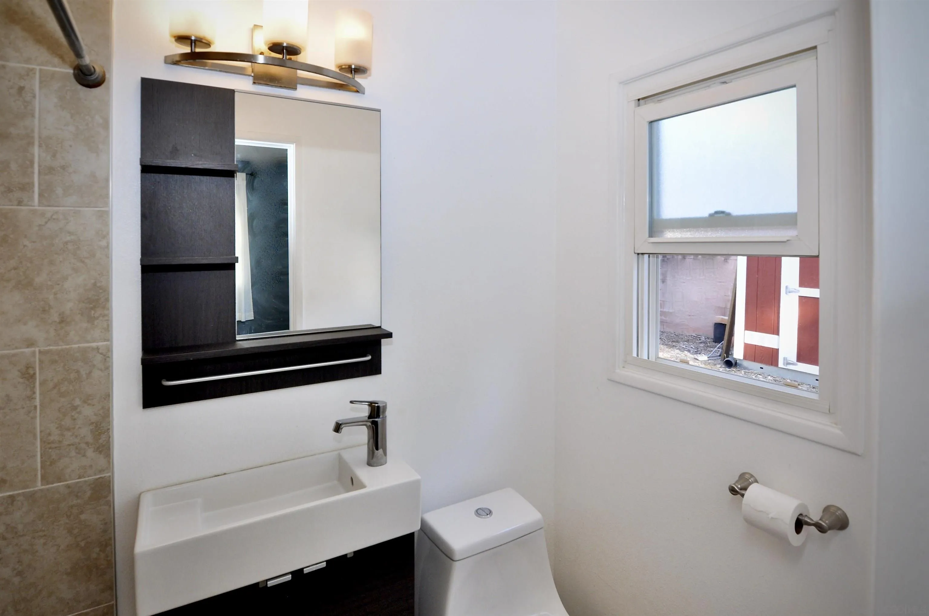 12549 Taunt Place Poway, CA 92064 - Photo 20 of 38 a bathroom with a sink a toilet and a window