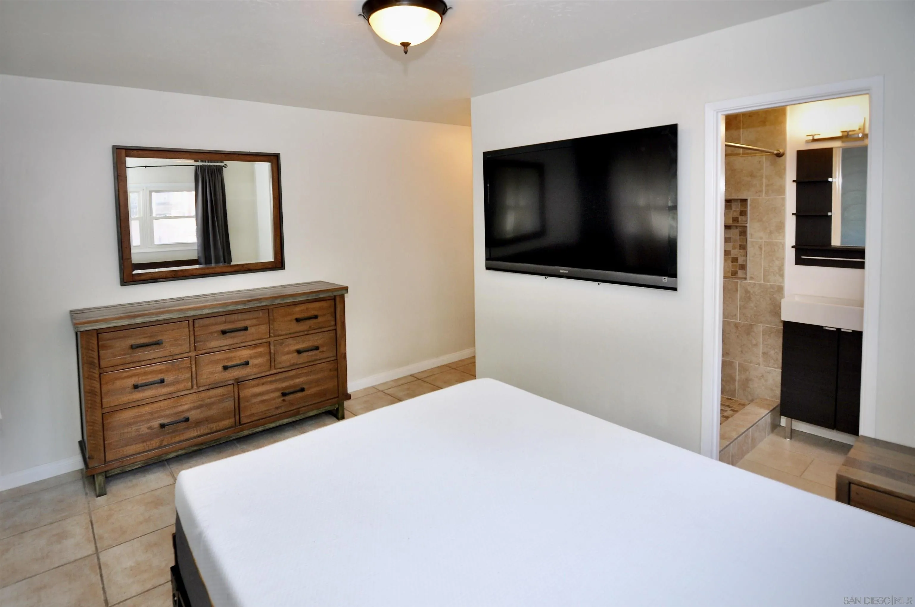 12549 Taunt Place Poway, CA 92064 - Photo 22 of 38 a bedroom with a bed and a flat screen tv