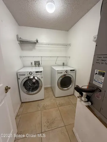 a utility room with sink dryer and washer